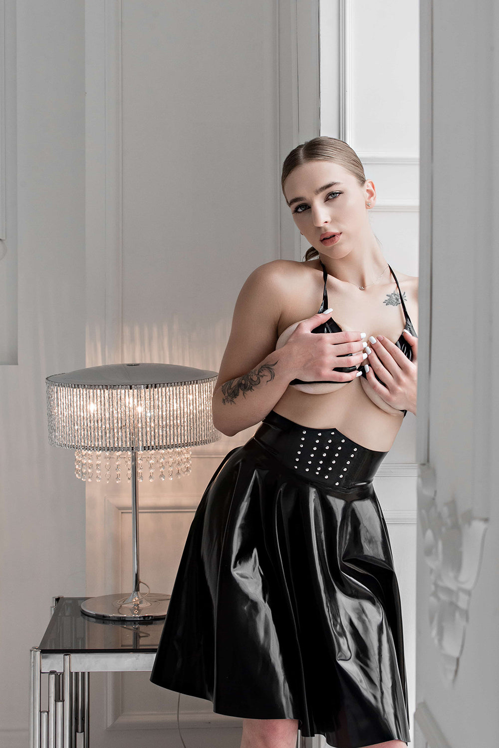 Latex high-waisted skirt with metal rivets. Black