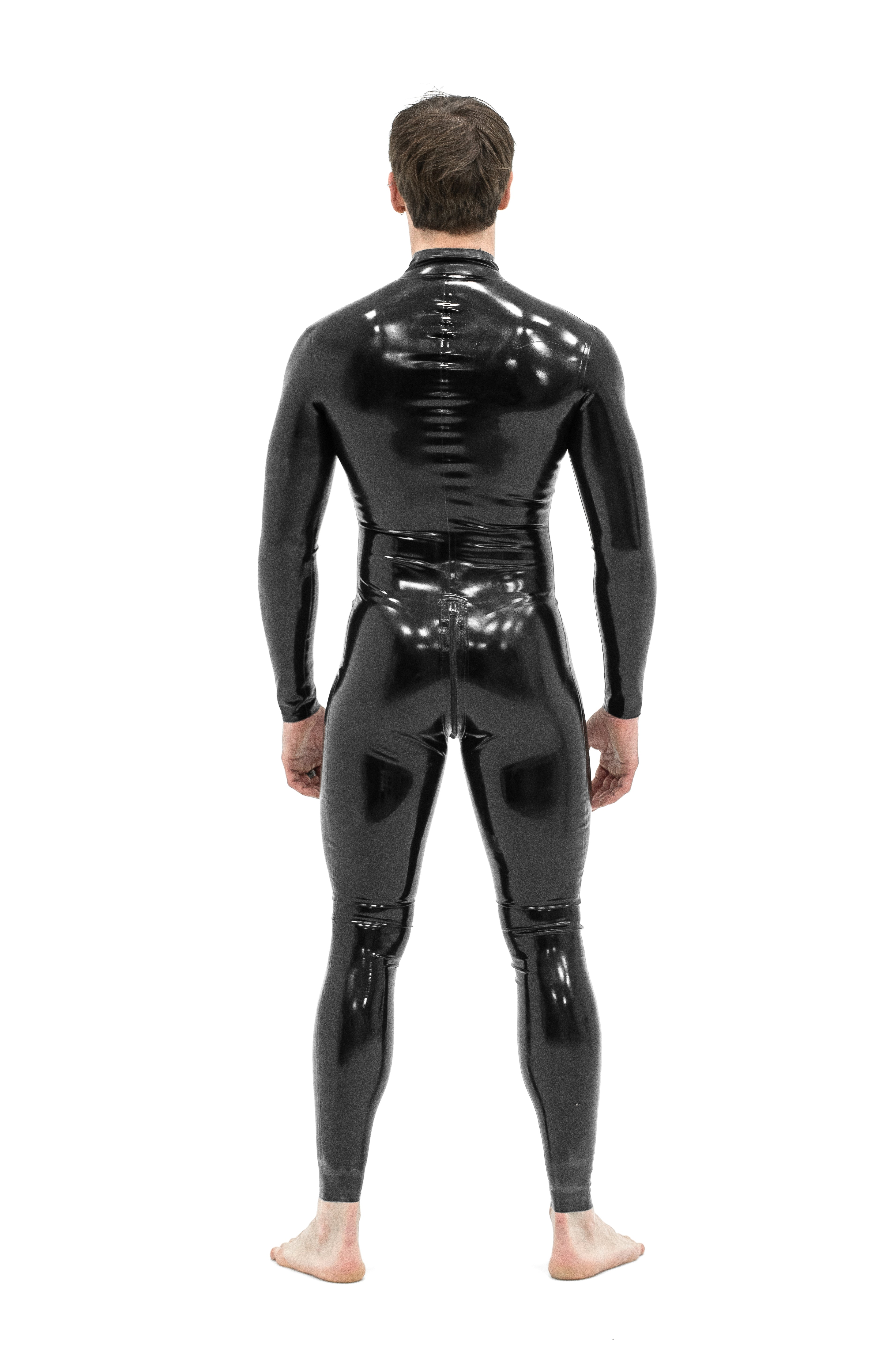 Man in a black latex catsuit, back view